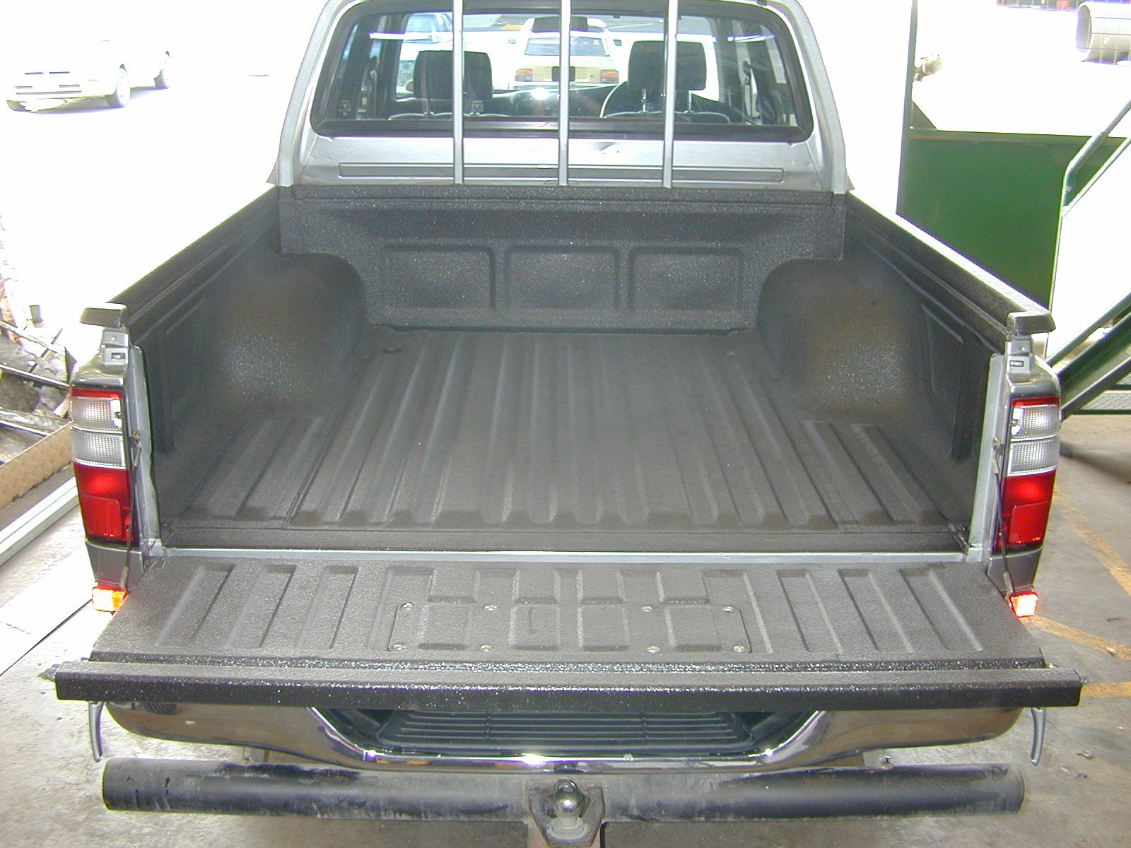 Polyurea bed liner and rust barrier applied to pickup bed
